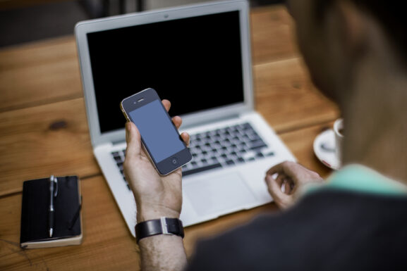 Small business owner working on local SEO using a laptop and smartphone