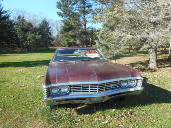 Used car with a for sale sign in the window