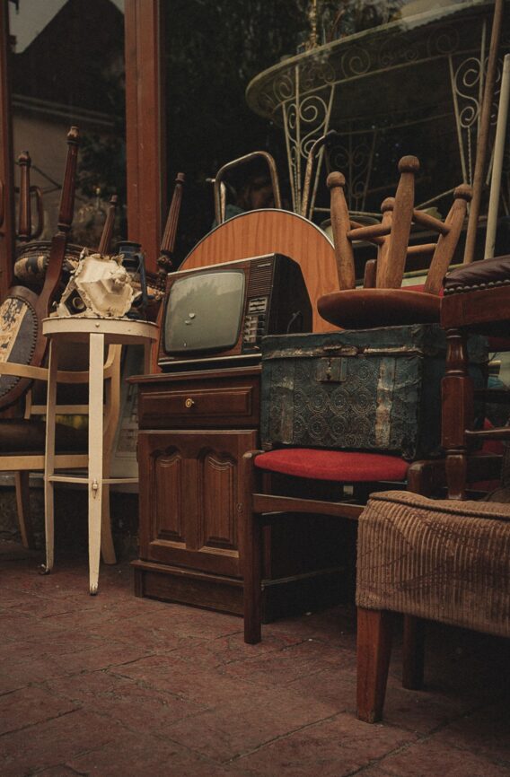 Assorted used furniture displayed inside an antique store, illustrating common myths about buying secondhand furniture
