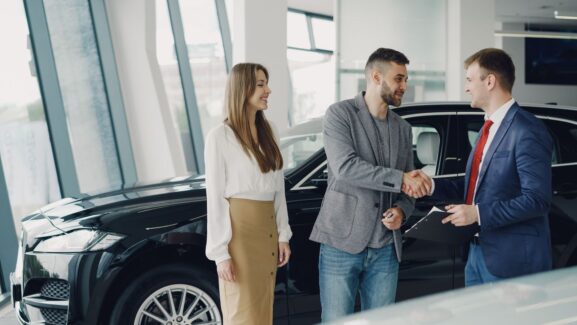A customer reviewing a purchase agreement for a used car, illustrating common pricing mistakes sellers make