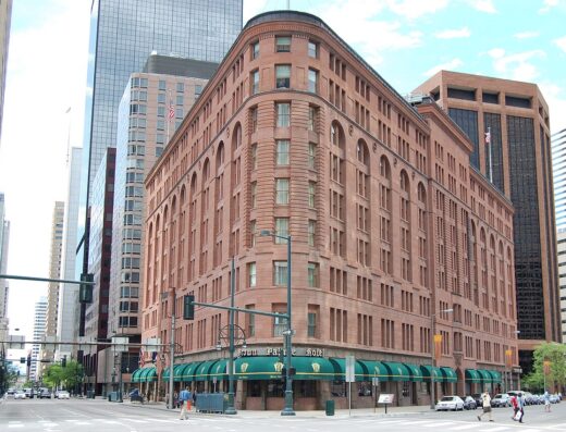 Red granite and sandstone exterior of the historic Brown Palace Hotel in downtown Denver