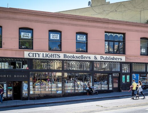 Storefront of City Lights Booksellers & Publishers on Columbus Avenue in San Francisco, with people on the sidewalk