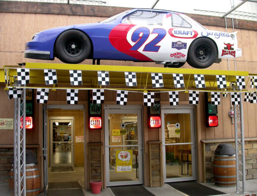 Main entrance of Jungle Jim's International Market in Fairfield, Ohio, with a race car mounted above the doors