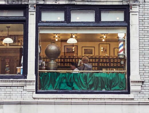 Paul Molé Barber Shop second-floor window on Lexington Avenue with barber pole