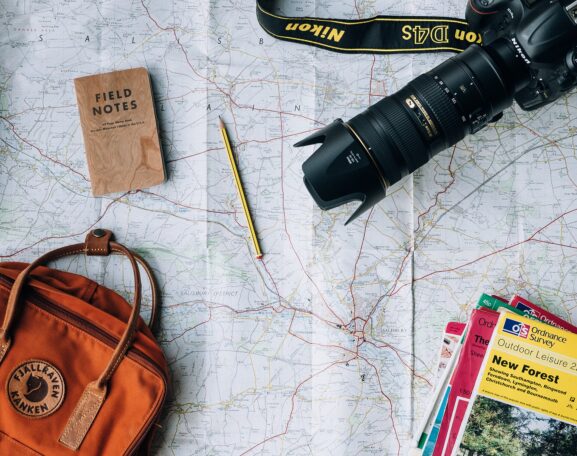Person planning a day trip with a map and notebook